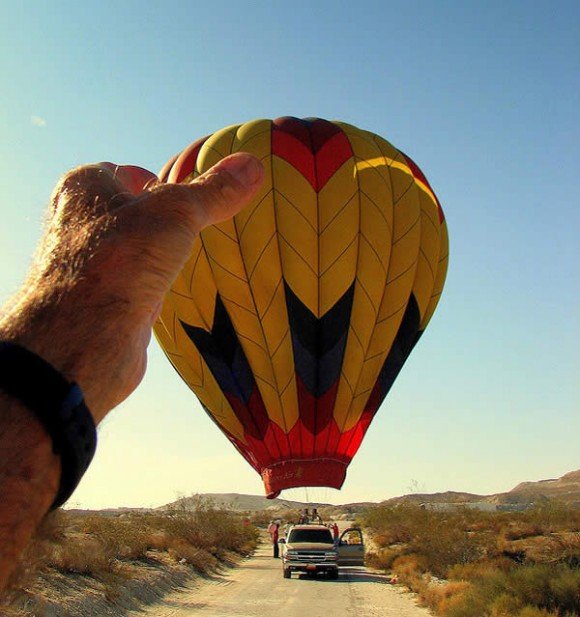 Holding a balloon.